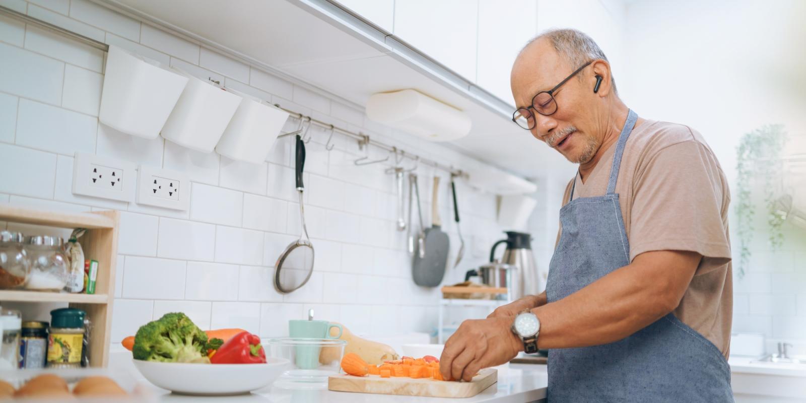 older_asian_man_cooking_healthy_meal older_asian_man_cooking_healthy_meal